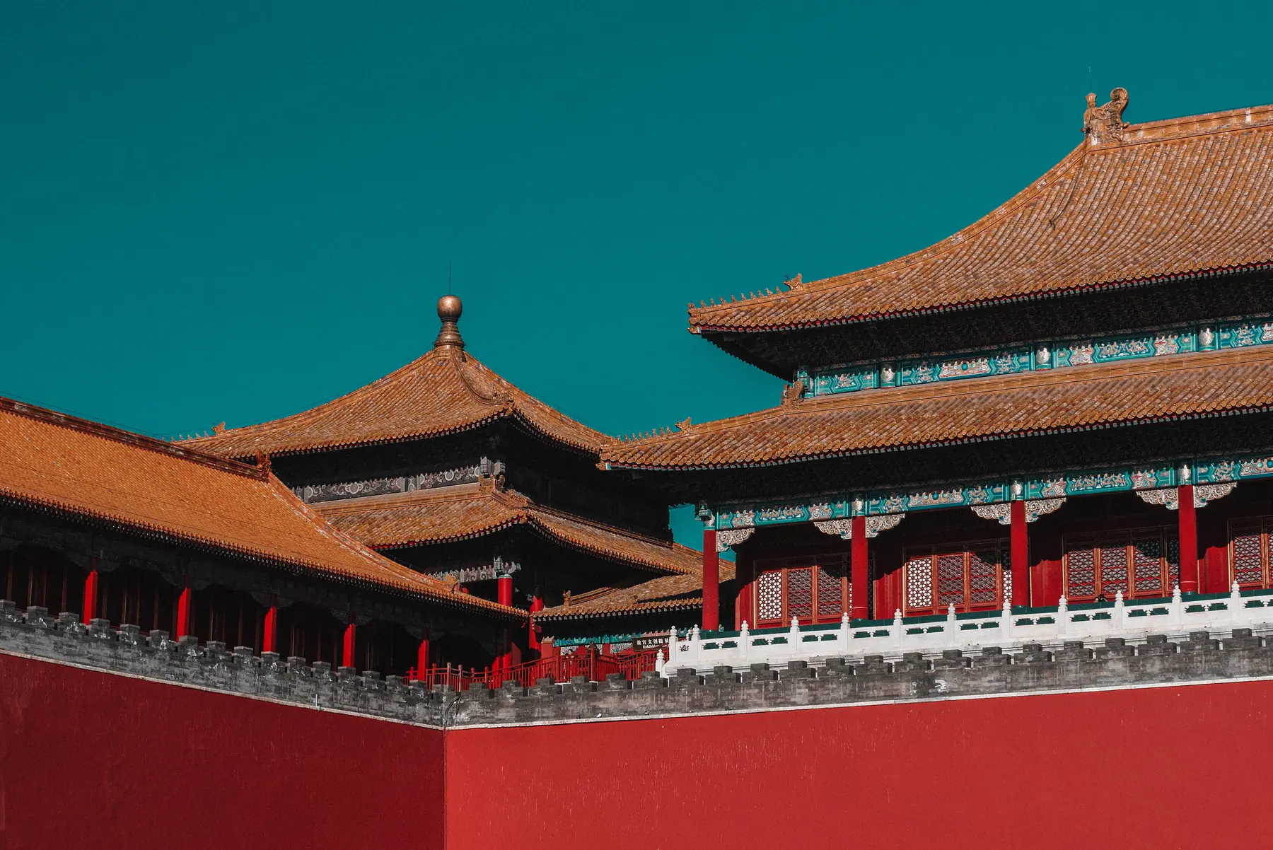 Palace roofs and painted eaves against a blue sky