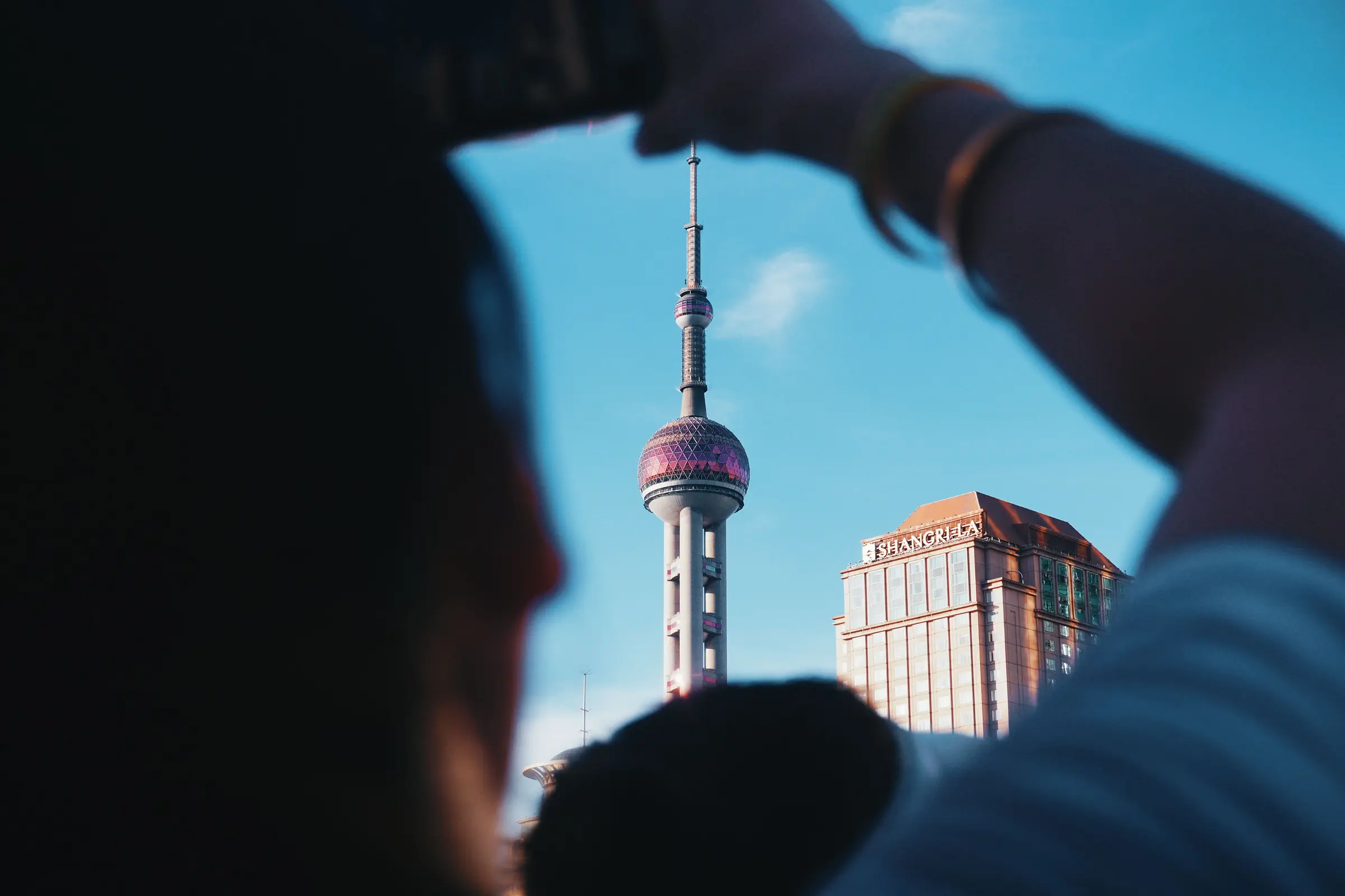 People moving through a dense Shanghai streetscape