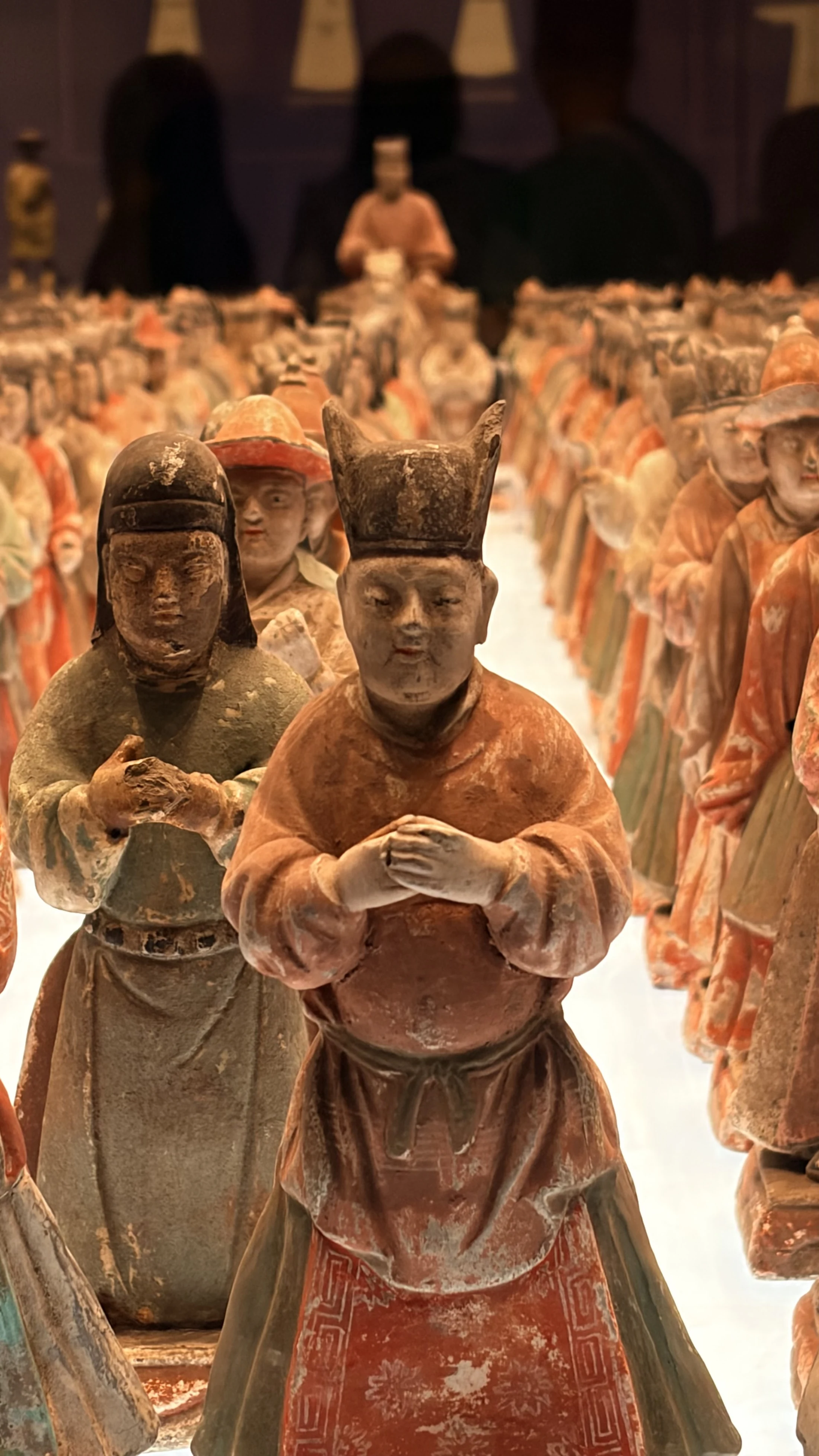 A dense procession of painted court figures displayed at the Shaanxi History Museum